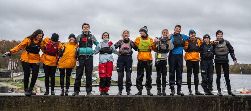 The team members standing on a wall